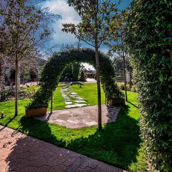 Arco vegetal y paseo de losas en el jardín